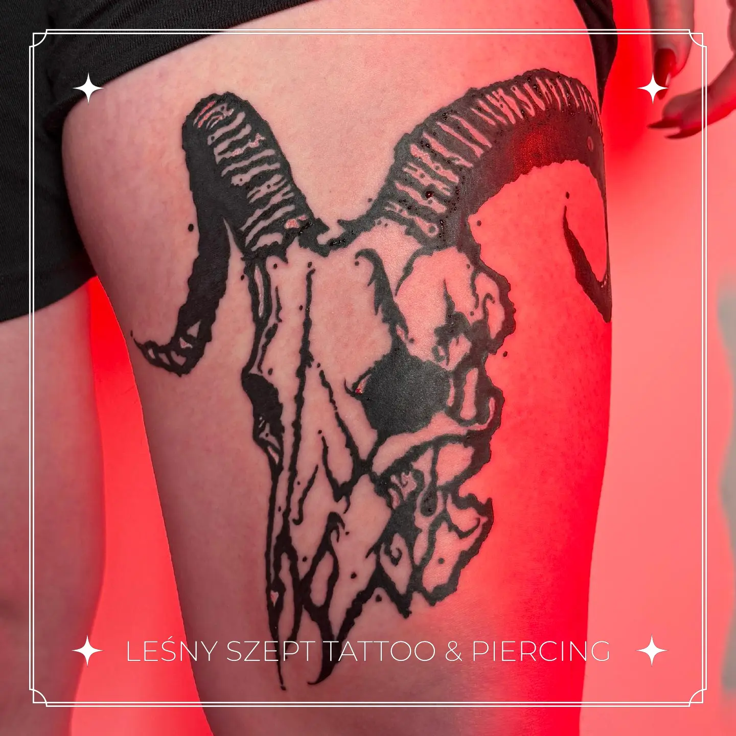 Tatuaż dużej kozłej czaszki z zakręconymi rogami w stylu blackwork na udzie